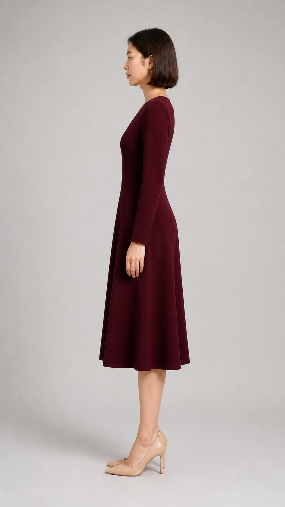Side appearance reference of an adult woman wearing a burgundy midi dress